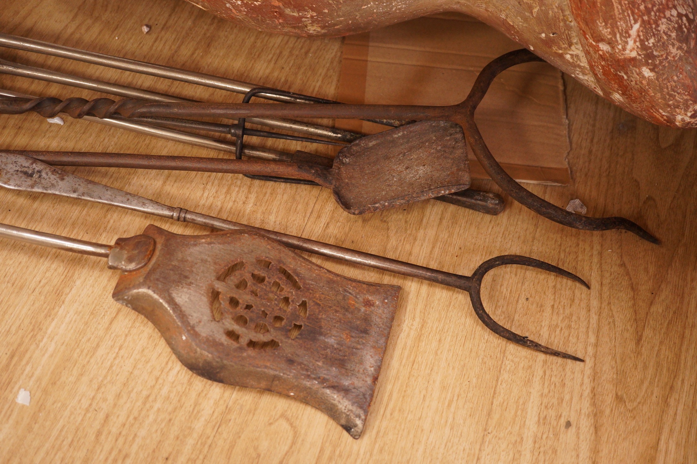 A set of three 19th century steel and brass fire irons and others